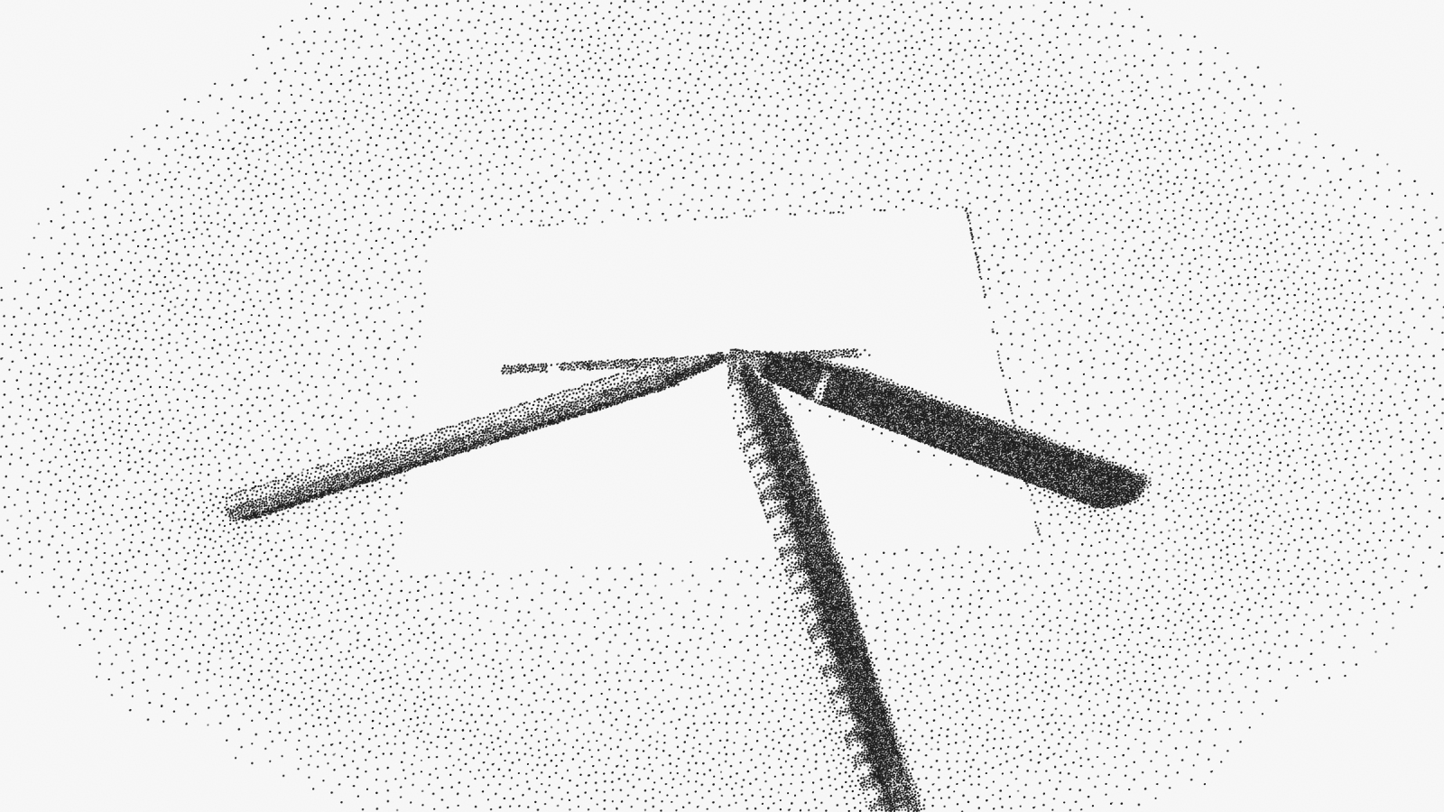 A pencil, a fountain pen and a dip pen lying on a sheet of paper, their three points meeting at the same word of a single line.
